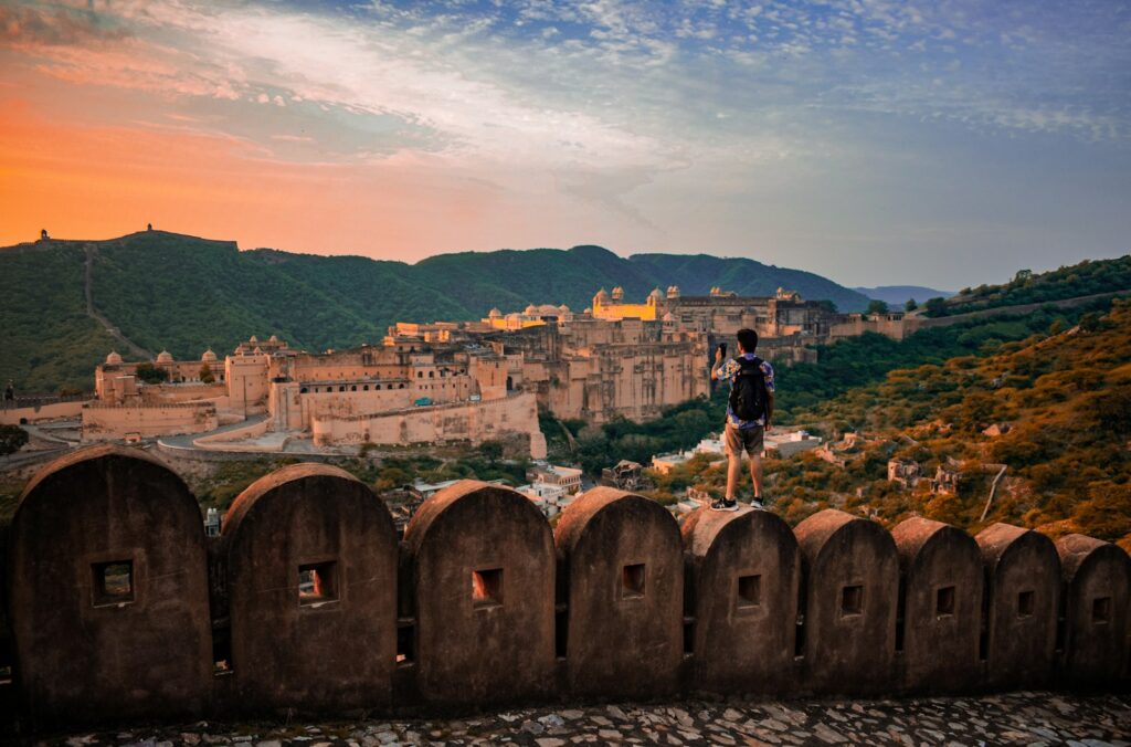 a man standing on top of a stone wall